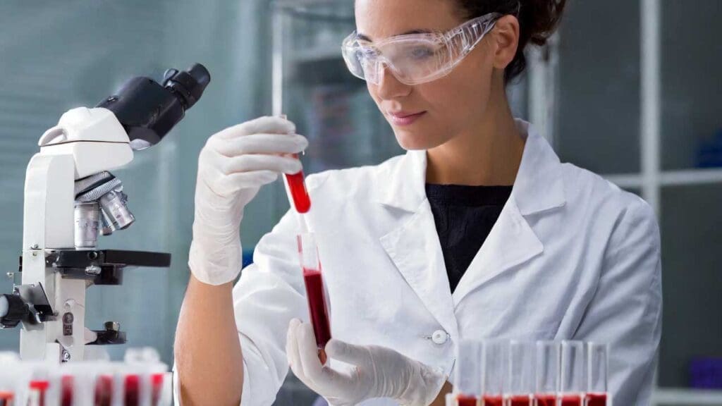 Medical laboratory scientist performing serologic crossmatch procedure in a blood bank.